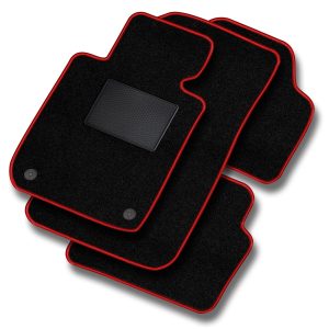 Set of black car floor mats with red edging stacked diagonally, textured surface visible